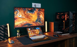 a laptop computer sitting on top of a wooden desk
