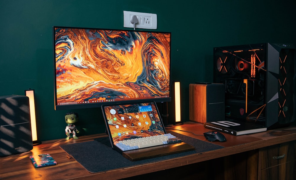 a laptop computer sitting on top of a wooden desk