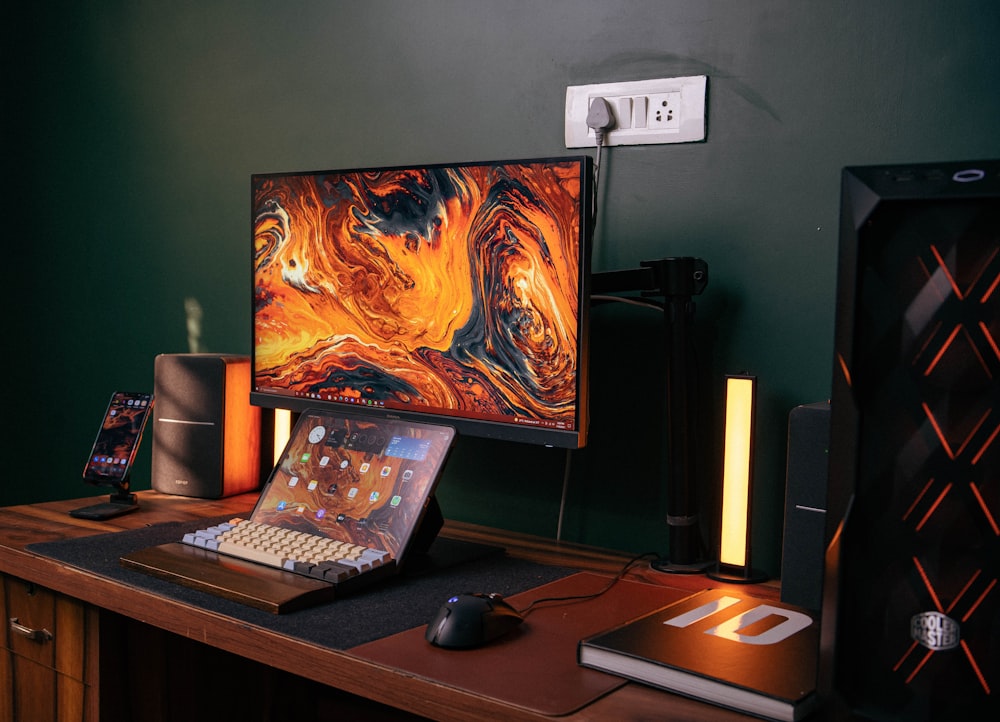 a desk with a laptop and a monitor on it