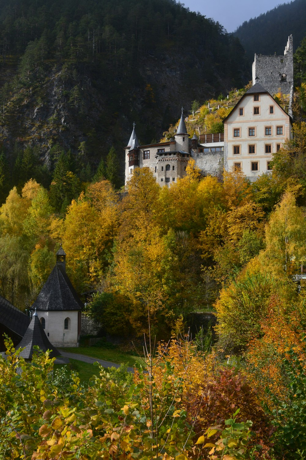 a scenic view of a village in the mountains