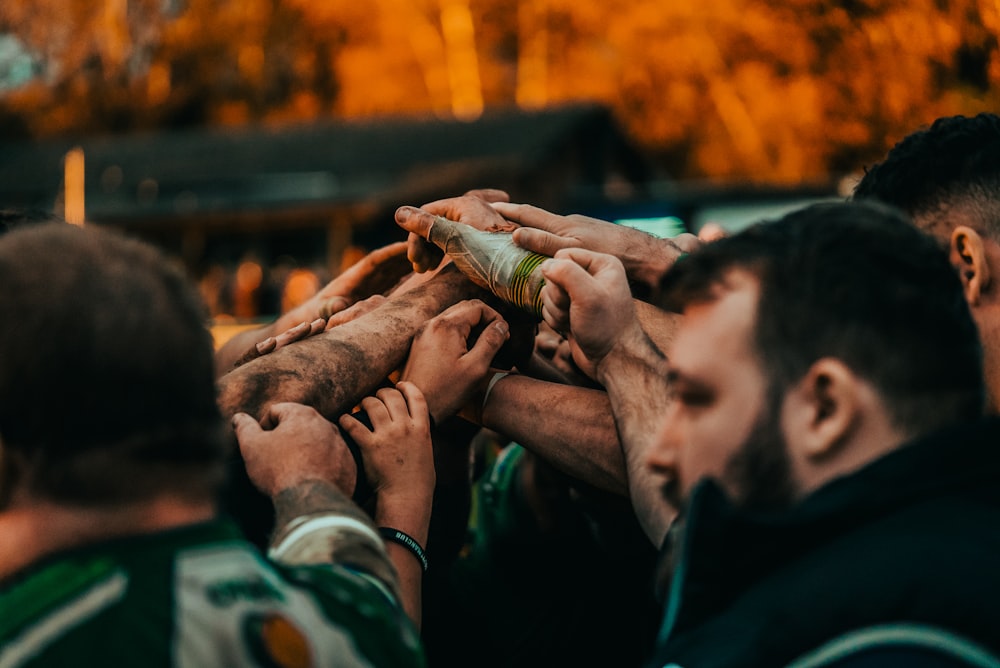 a group of people holding onto each other