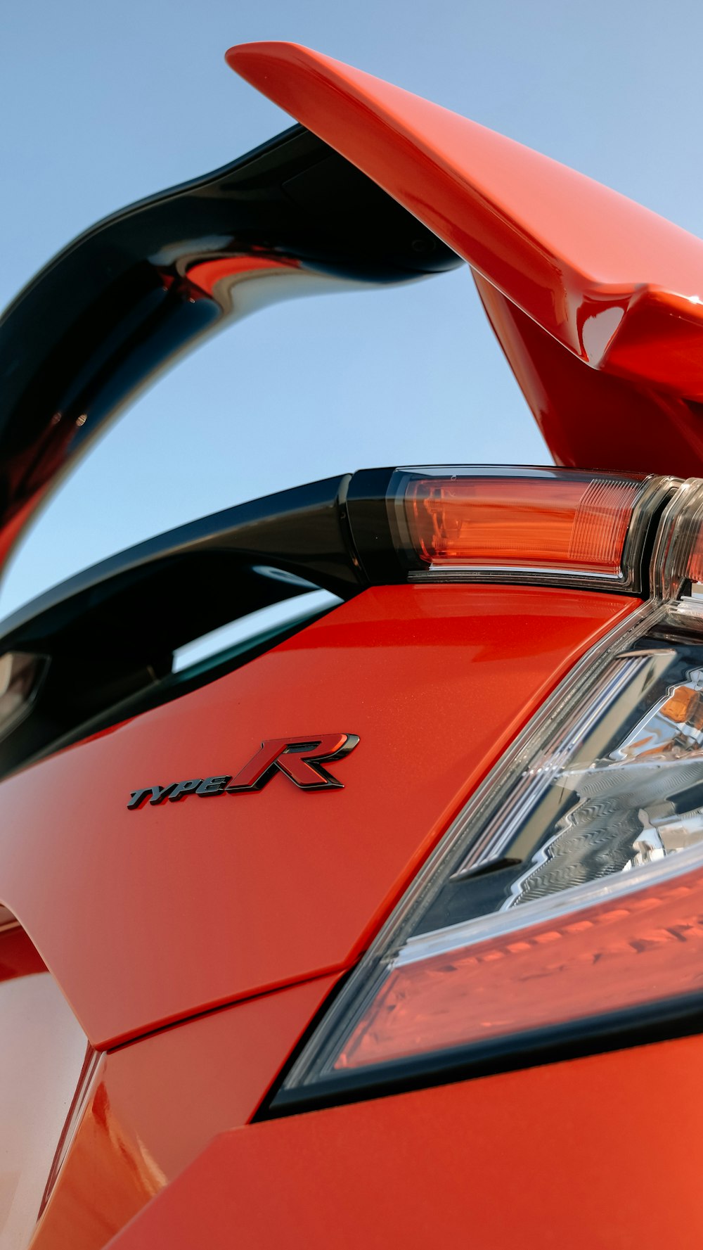 a close up of the tail lights of a red sports car