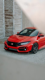 a red sports car parked in front of a building