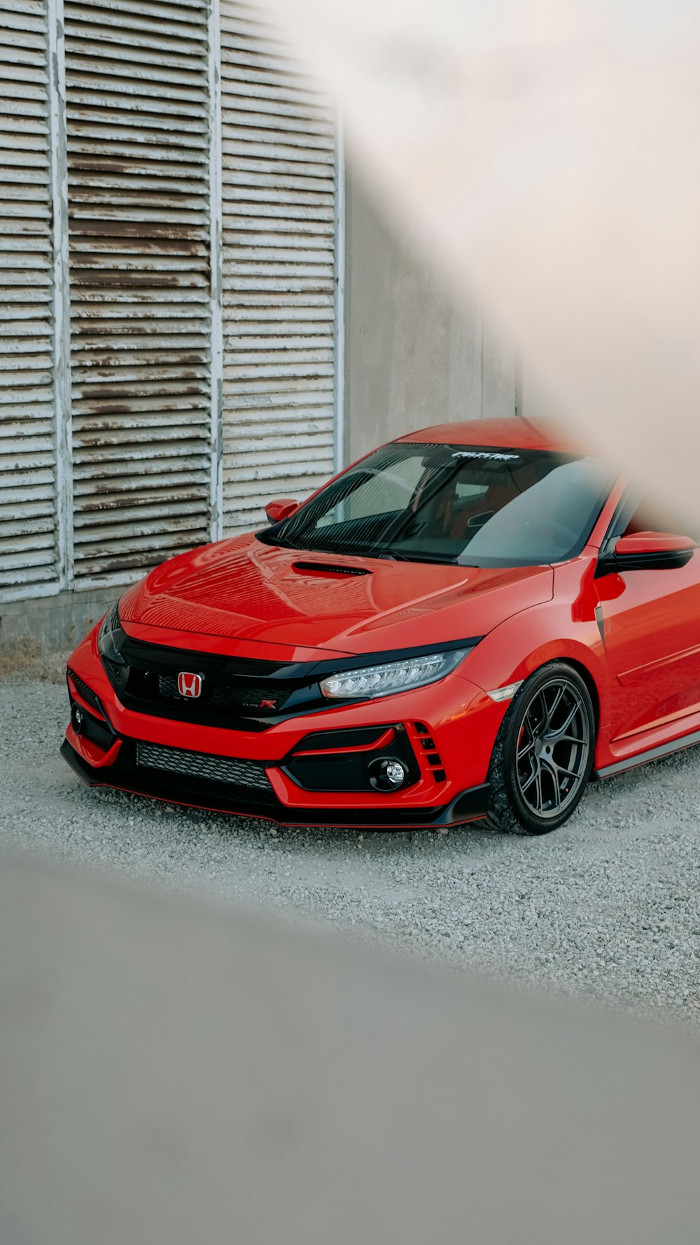 a red sports car parked in front of a building