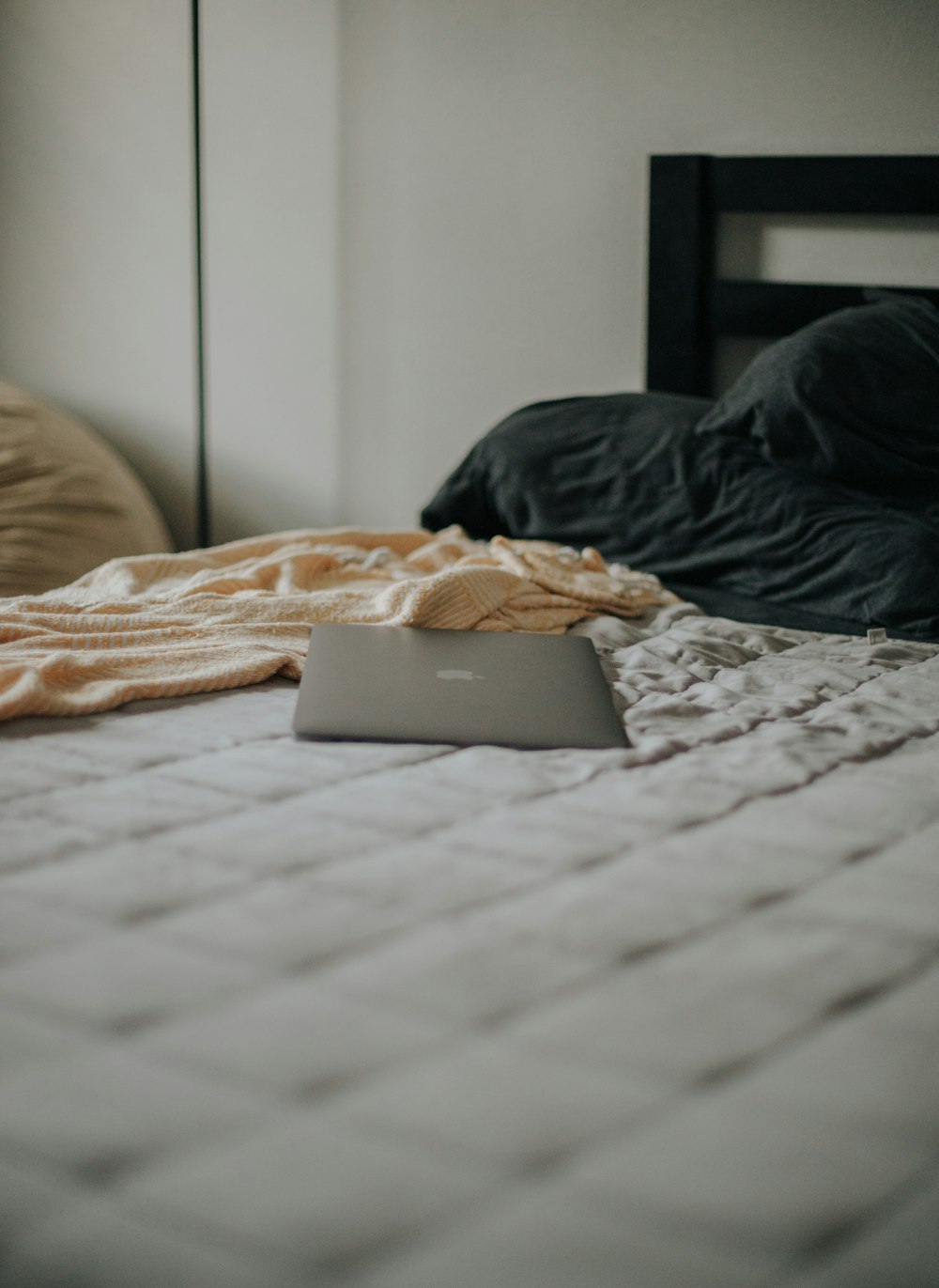 a laptop computer sitting on top of a bed