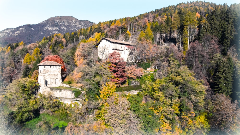 an old building sitting on top of a lush green hillside