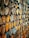 A dense arrangement of rusty, rectangular metal brackets stacked closely together, with chipped paint in shades of yellow and orange, creating a textured and industrial appearance.