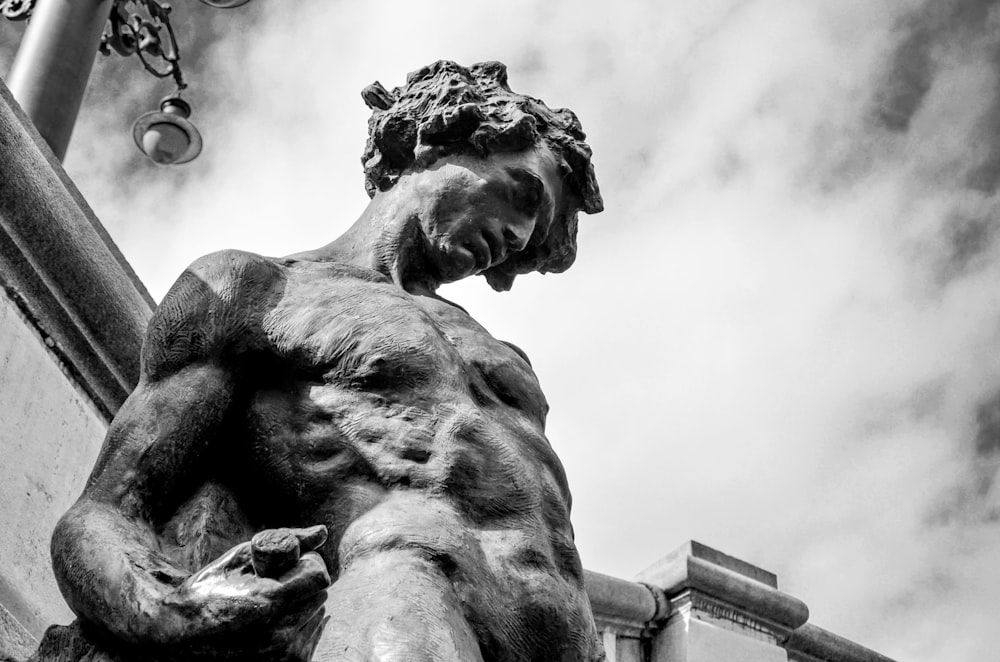 a black and white photo of a statue of a man