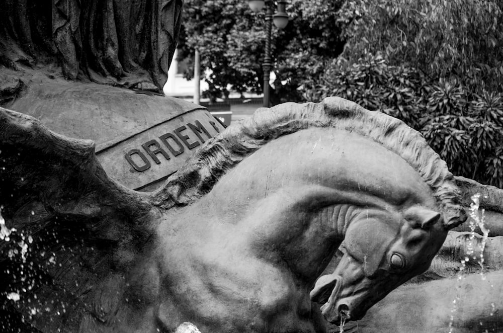 a black and white photo of a statue of a horse