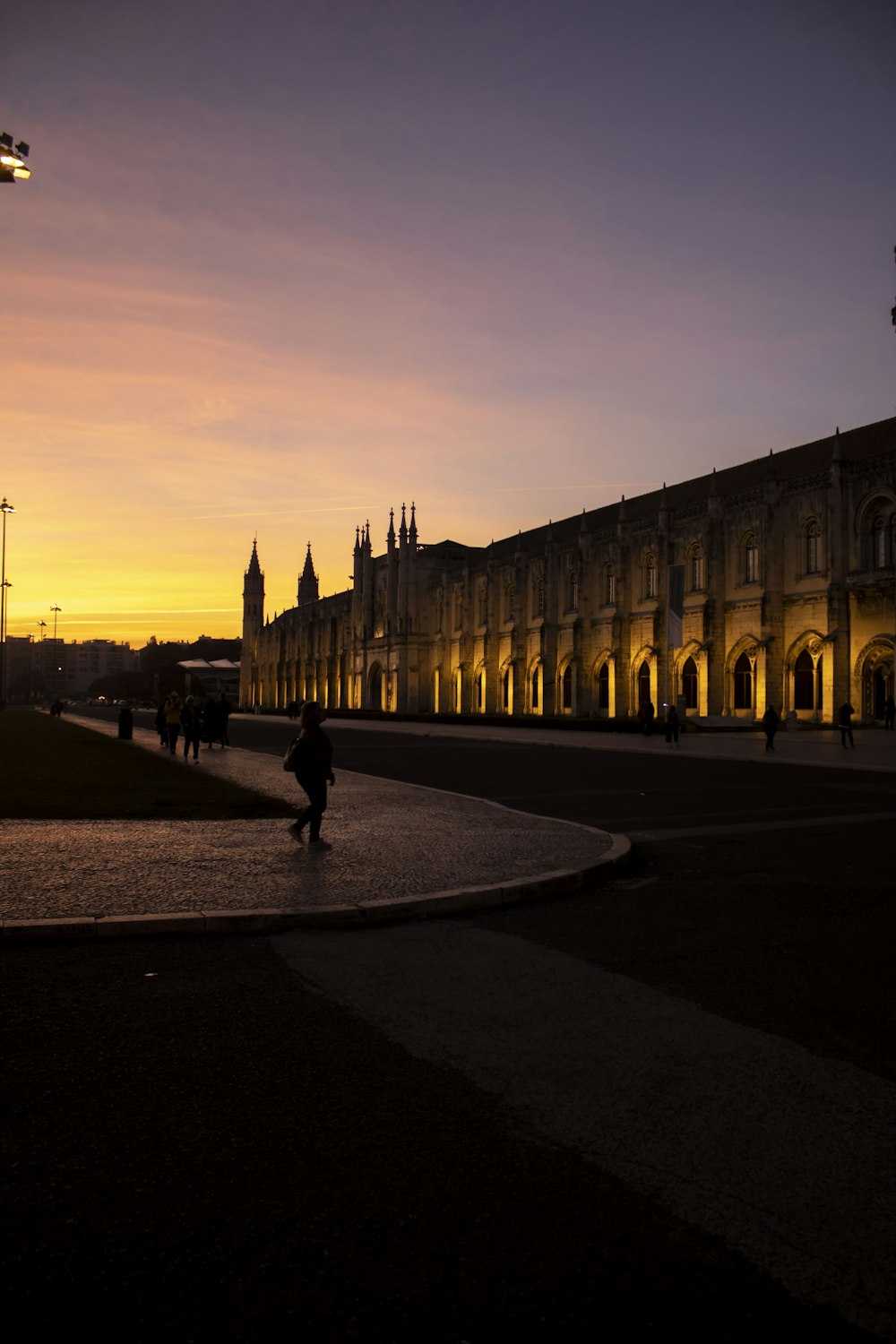 a person walking down a street in front of a building