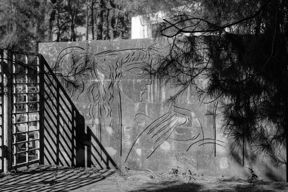 a black and white photo of graffiti on a wall