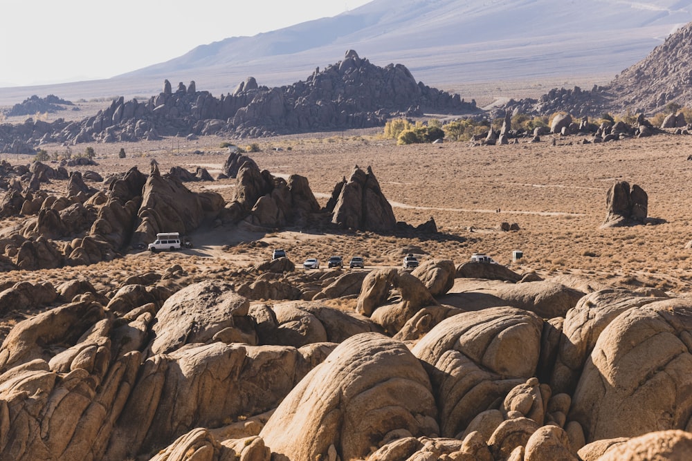 a desert landscape with rocks and mountains in the background