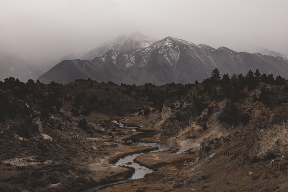 a mountain range with a stream running through it