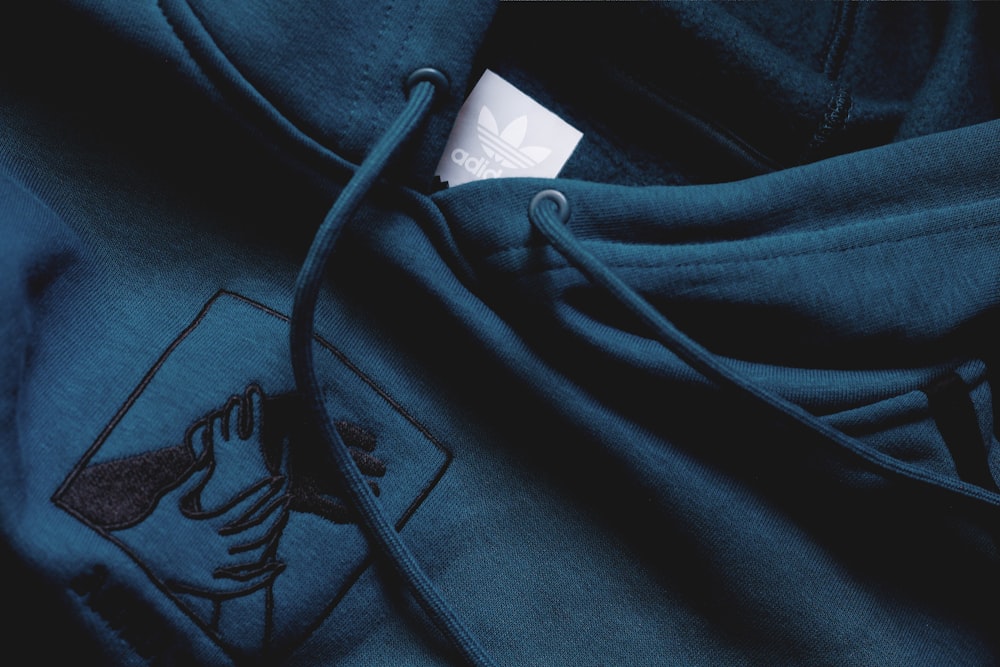 a close up of a hoodie with a tag on it