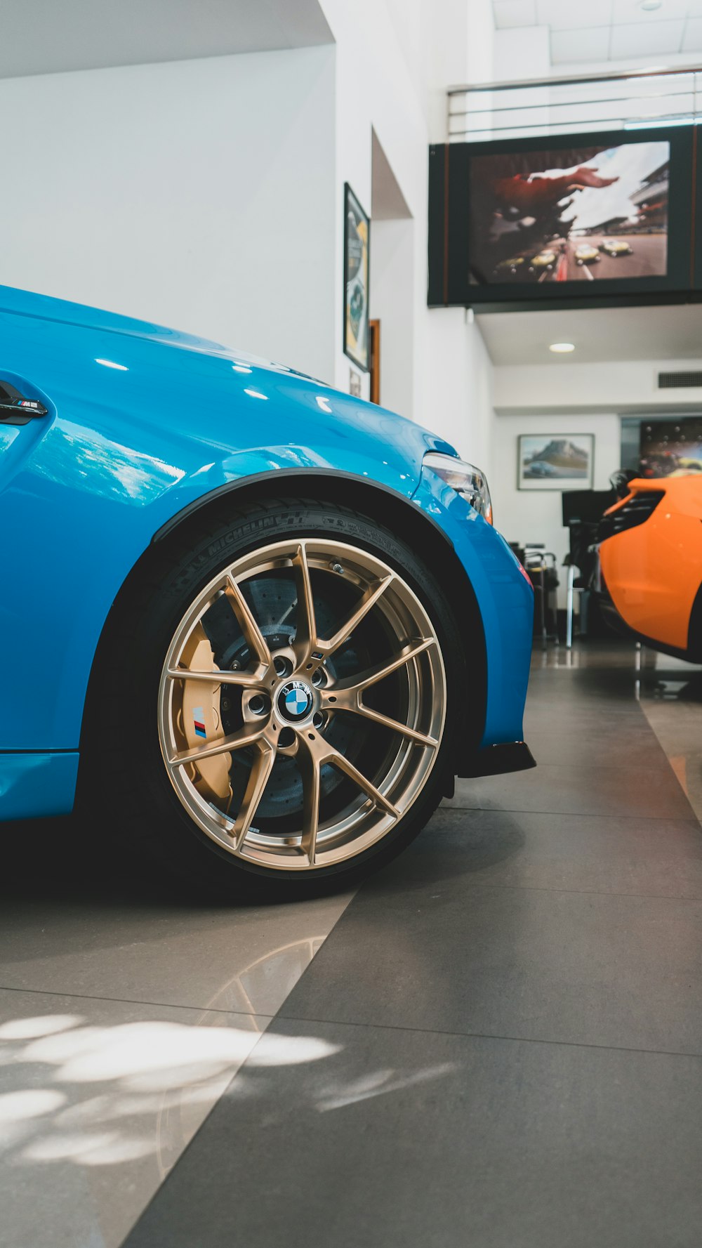 a blue sports car parked in a showroom