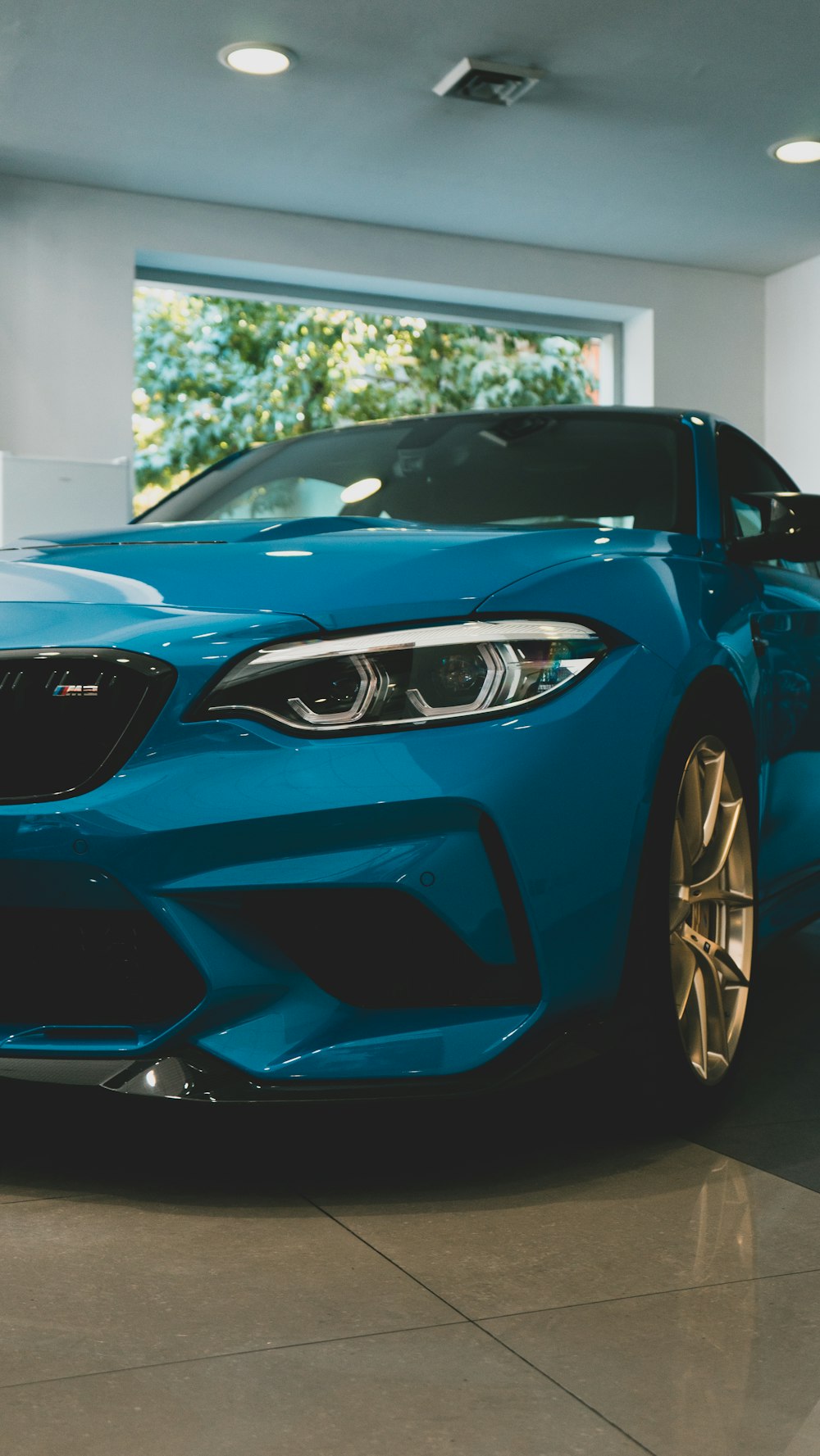 a blue sports car parked in a garage