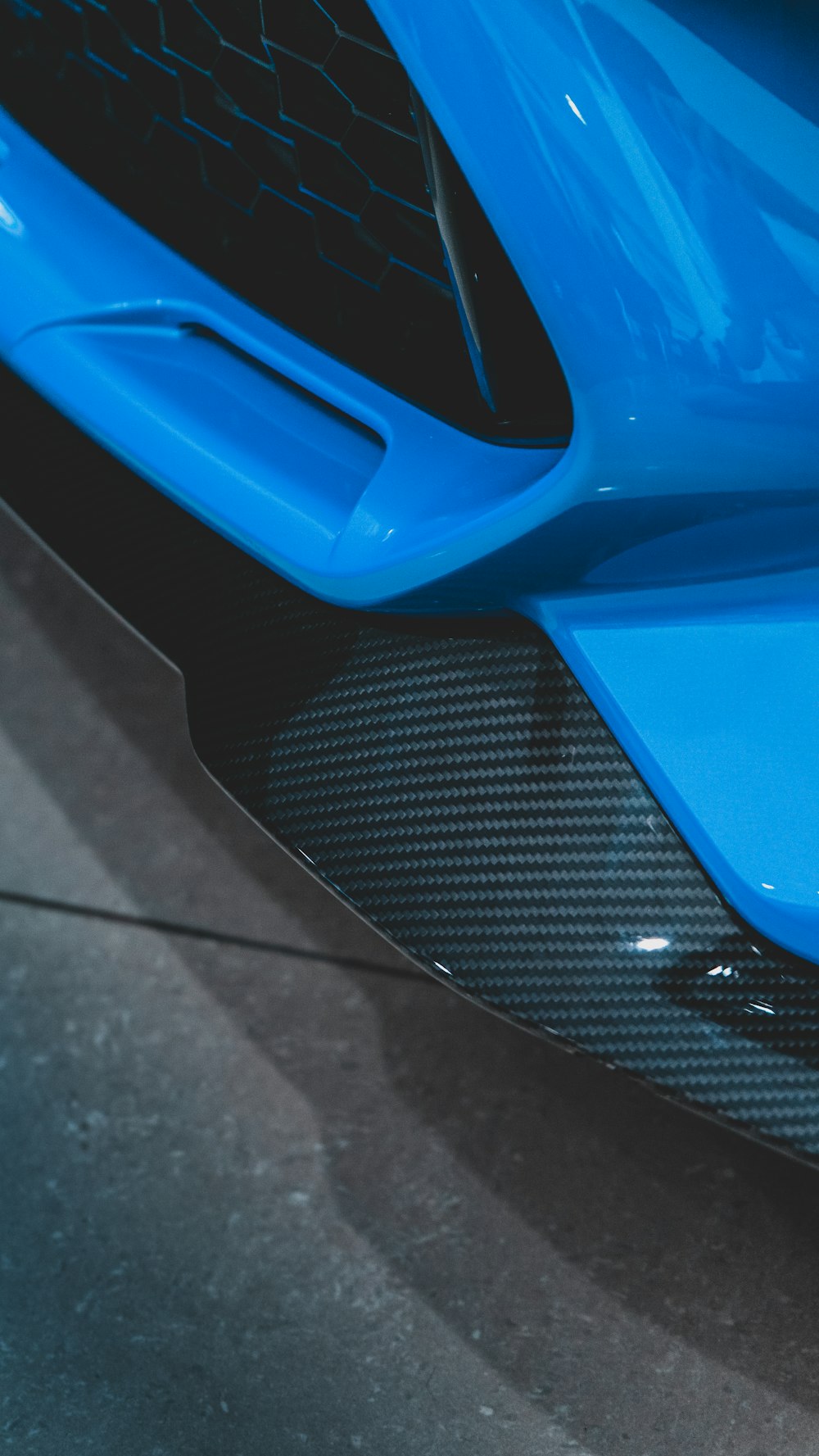 a close up of the front of a blue sports car