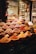 A vibrant display of various spices and herbs in a market setting, featuring bowls and piles overflowing with colorful powders and whole spices. The array is both rich and diverse, capturing the essence of a bustling spice market.