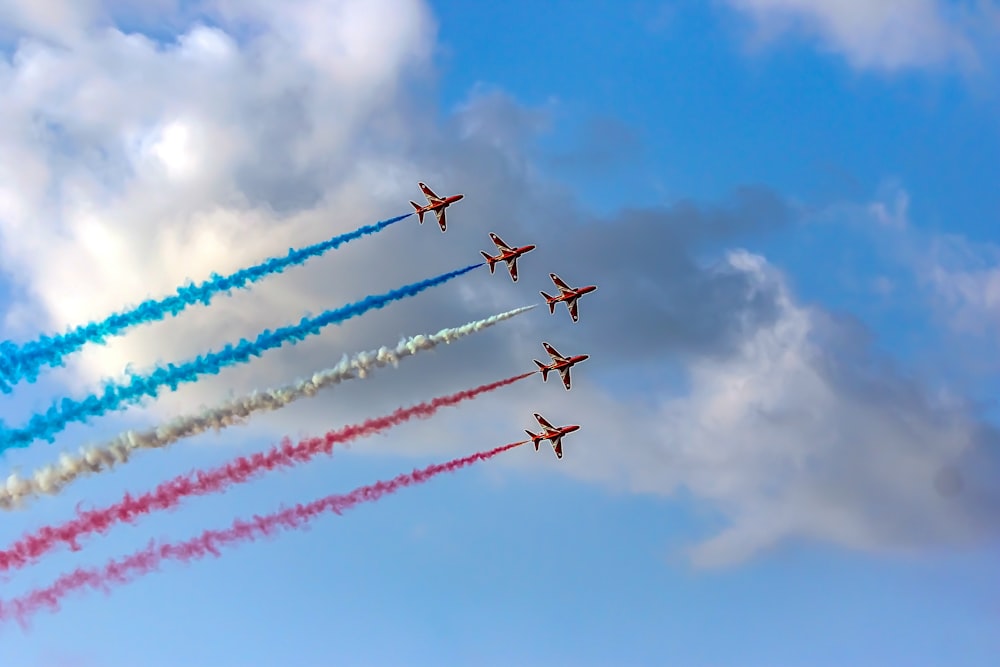 a group of airplanes flying through a cloudy sky