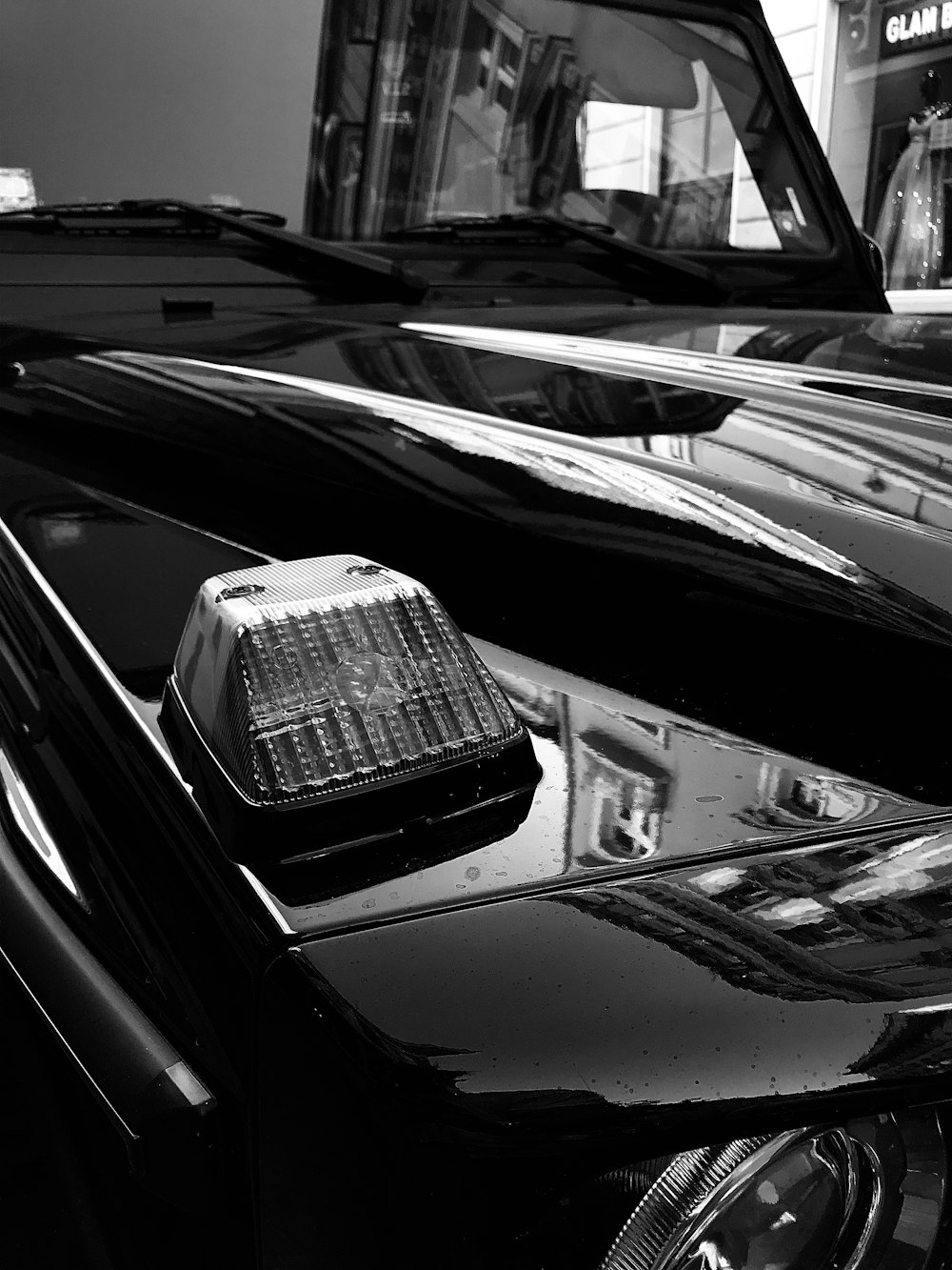 a black and white photo of a car and a bus