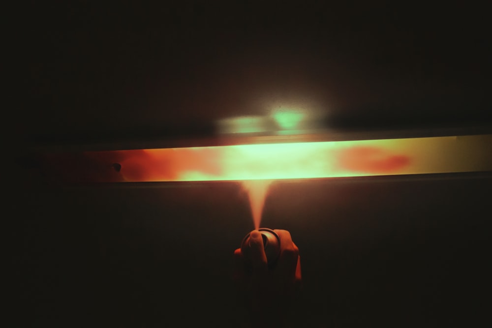 a person holding a lit object in the dark