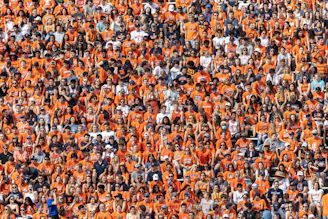 a large group of people in orange shirts
