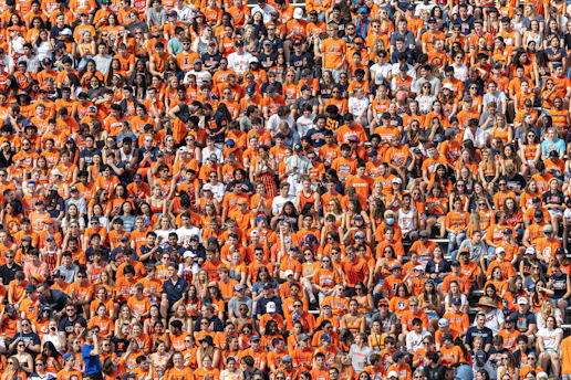 a large group of people in orange shirts