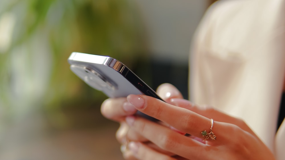 a close up of a person holding a cell phone