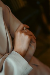 A person using Ringsizar to measure their finger size with augmented reality in a cozy home setting.