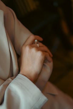 A person using Ringsizar to measure their finger size with augmented reality in a cozy home setting.