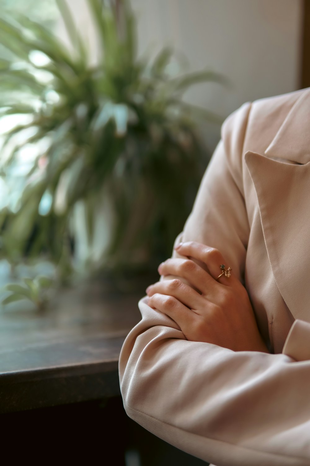 a woman sitting at a table with her arms crossed