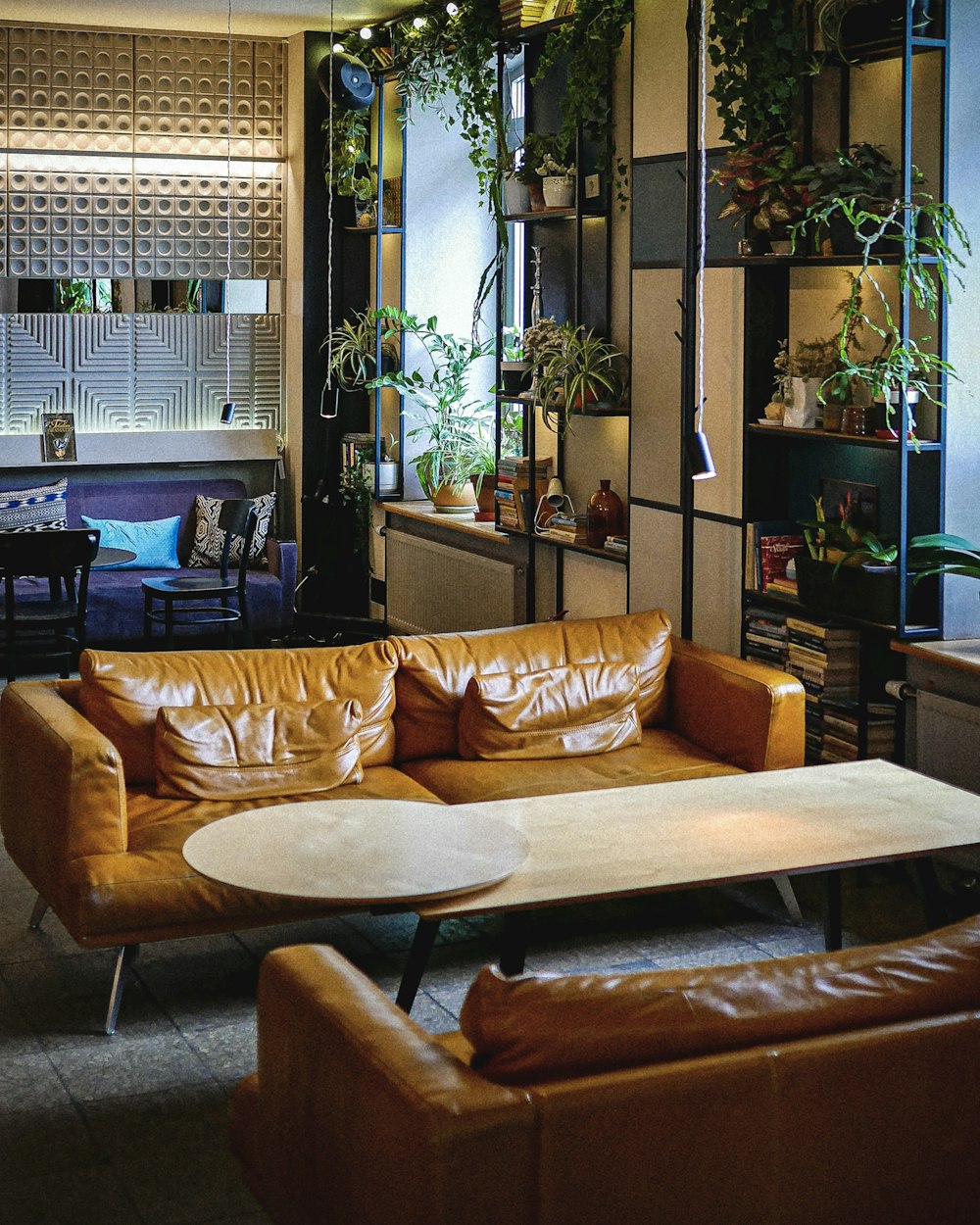 a living room filled with furniture and lots of plants