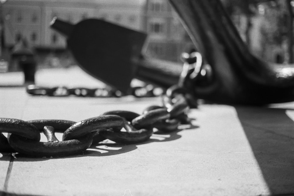 a black and white photo of a chain on the ground