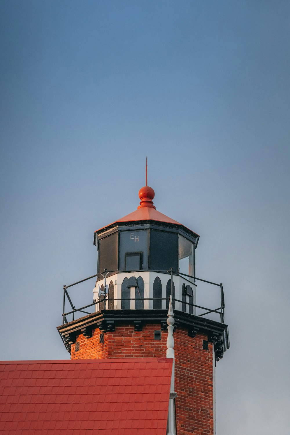 a light house on top of a red roof