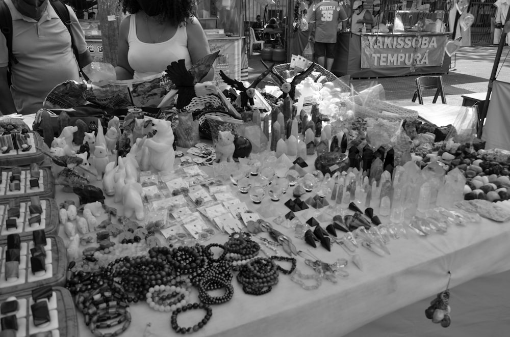 a black and white photo of a table full of items
