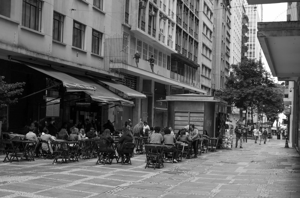 a black and white photo of people sitting at tables