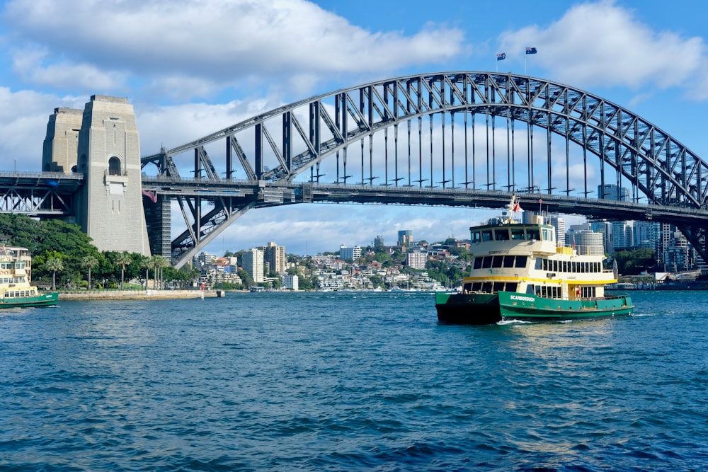 a boat in the water with a bridge in the background