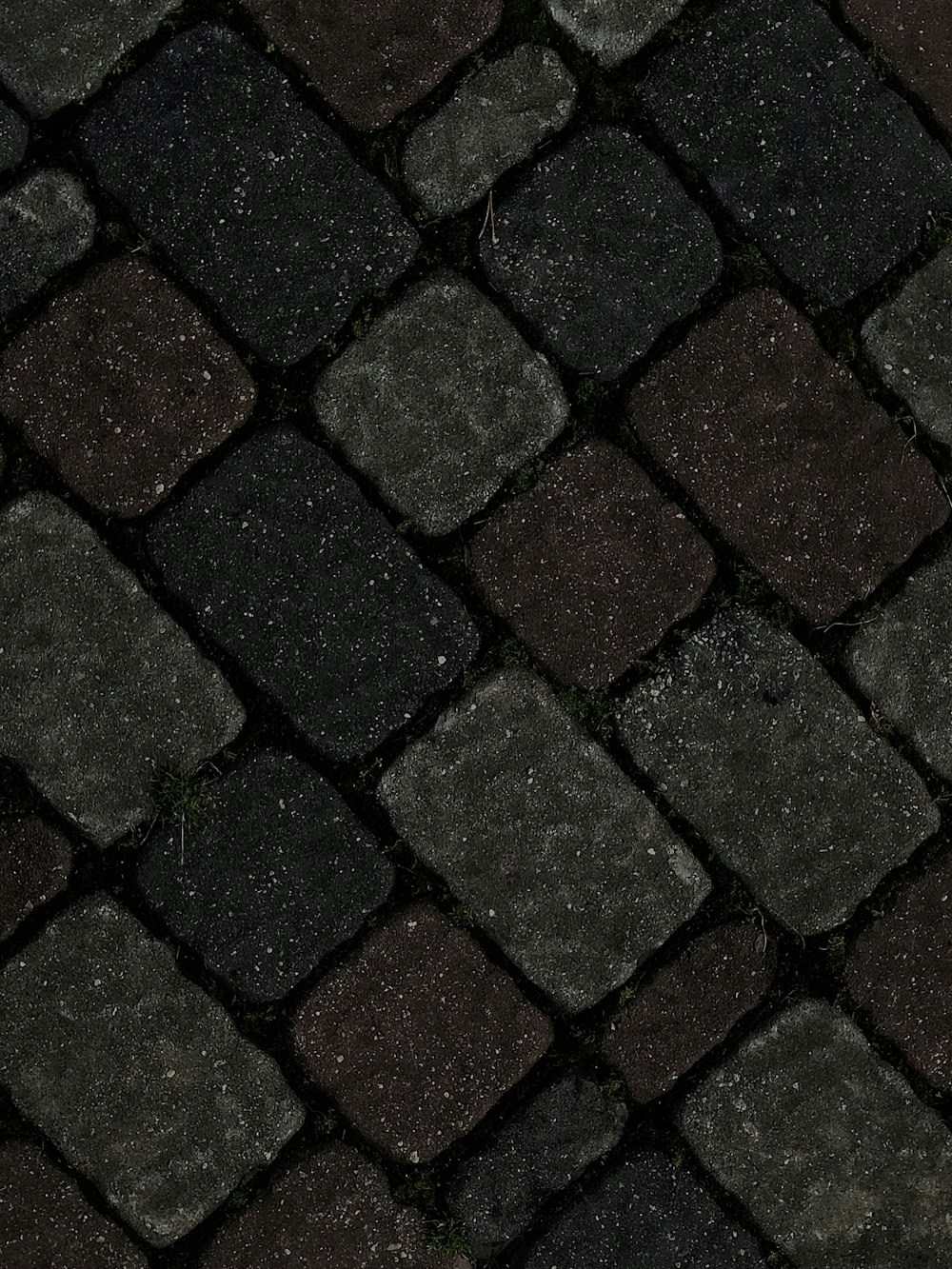 a close up of a black and brown tiled floor