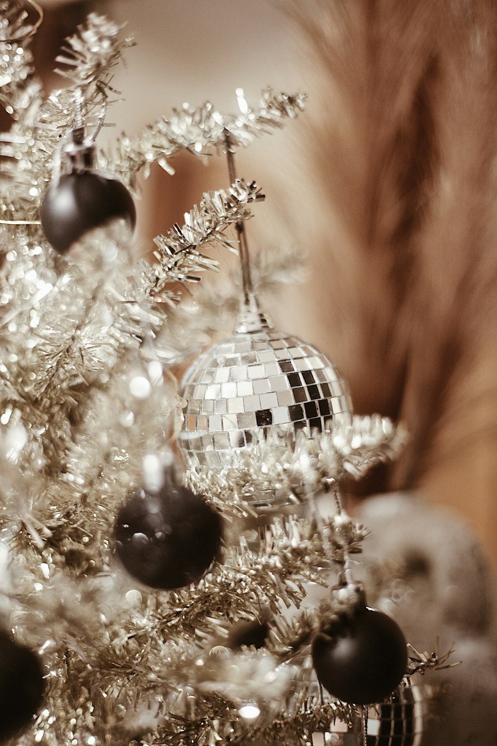 a silver christmas tree with disco ball ornaments