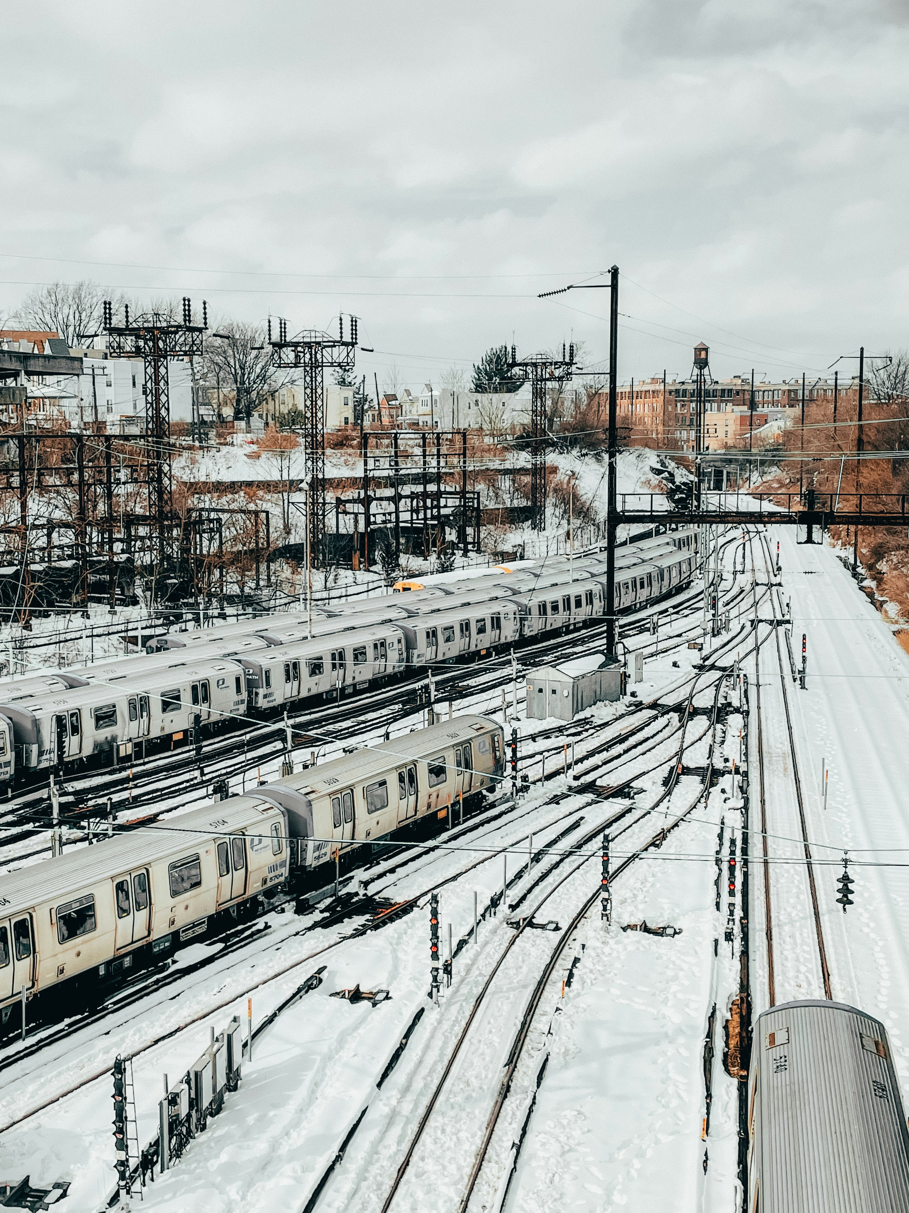 a train yard filled with lots of trains on tracks
