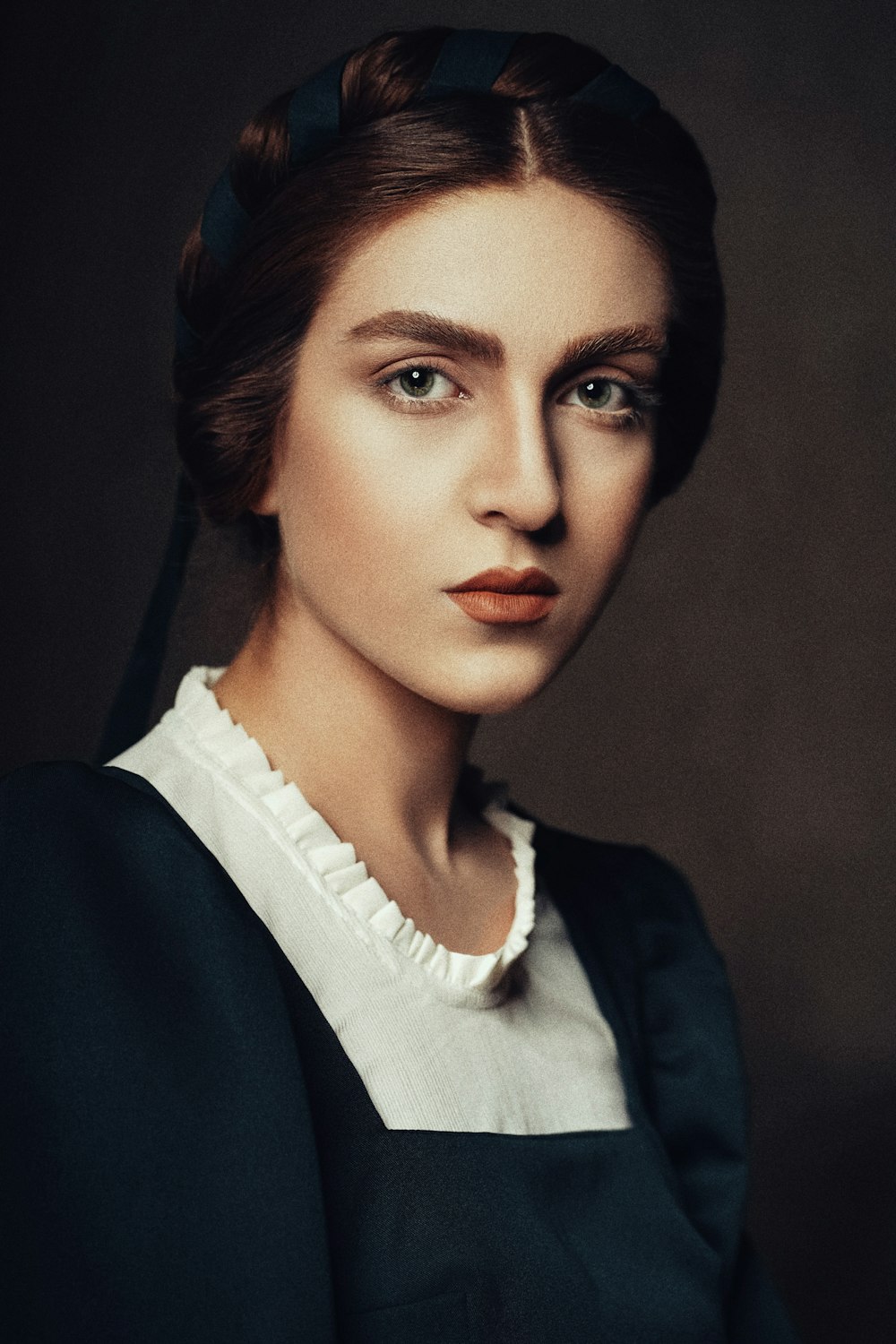 a woman wearing a black dress and a white shirt