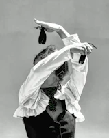 Close-up of hands gracefully moving during a flamenco dance, highlighting intricate finger movements.