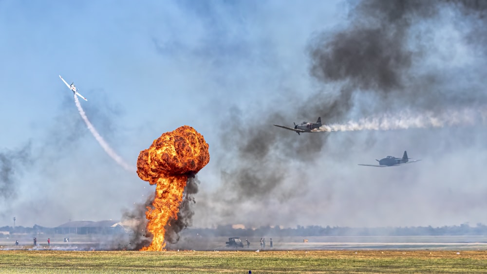 a plane is flying in the sky near a large explosion