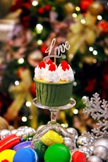 a cupcake with white frosting and a love sign on top