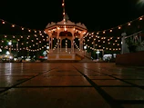 Gazebo netting draped elegantly around a garden seating area at dusk.