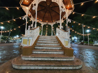 A modern gazebo with aluminum railing and integrated outdoor lighting in a chicagoland backyard.