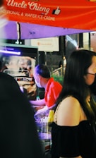 Delivery person handing over ice bags to a street food vendor in Yaowarat