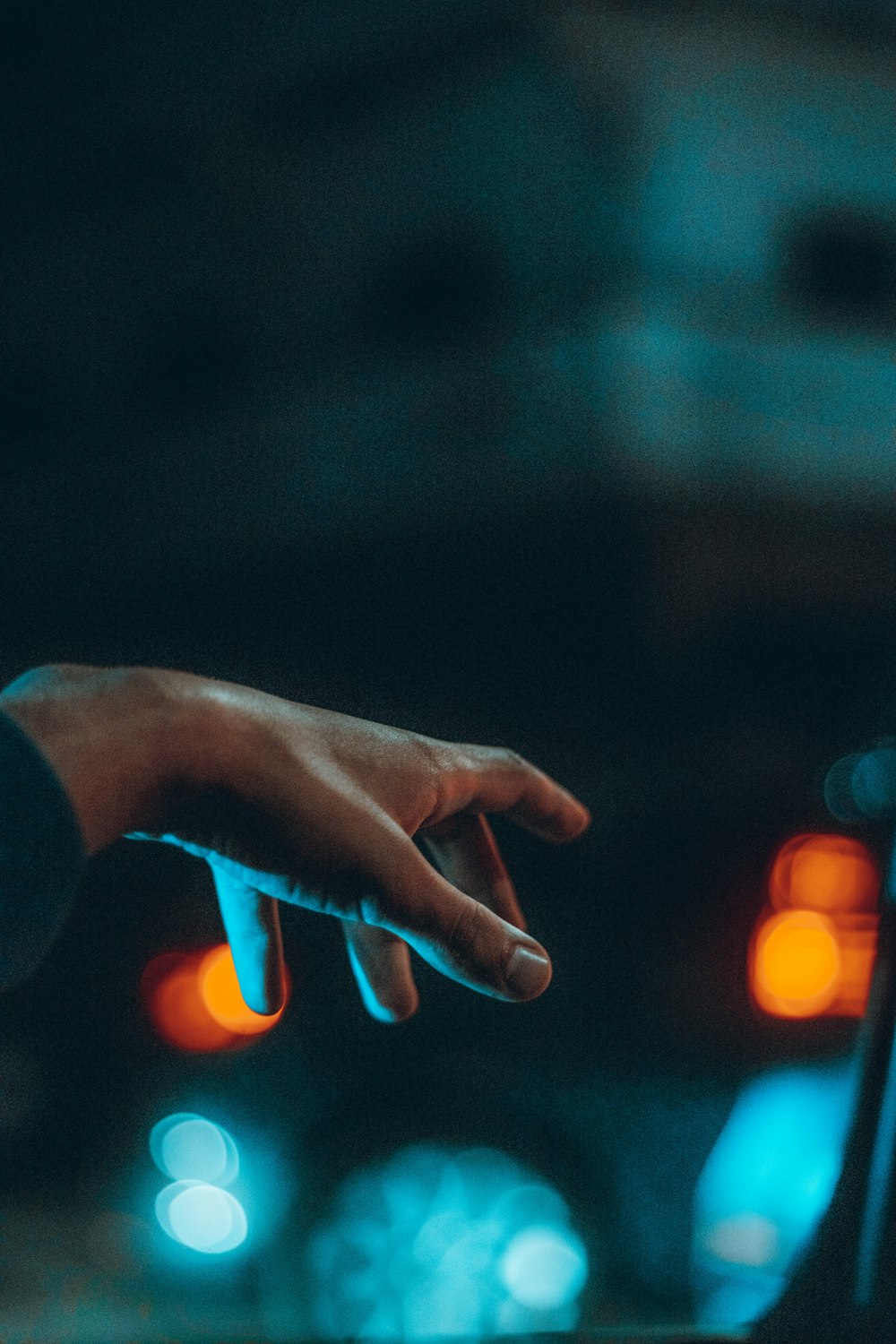 a hand reaching out of a car window