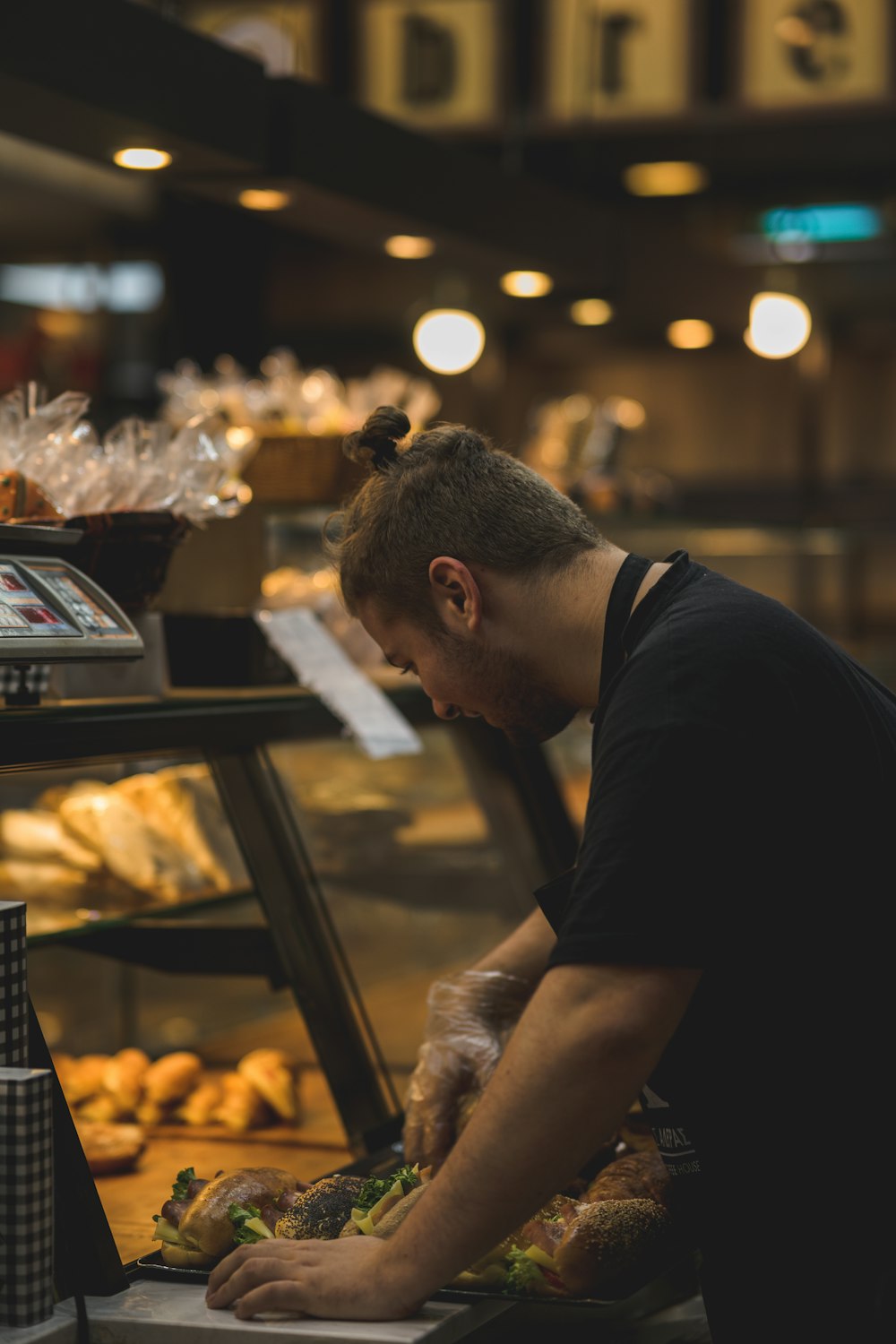 a man standing in front of a display of food