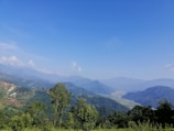 A scenic view of green hills under a clear blue sky.